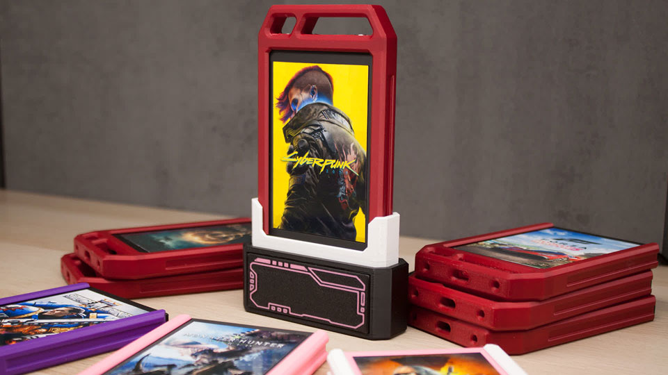 Une cartouche de Cyberpunk 2077 insérée dans un lecteur SATA et entourée d'autres cartouches aux coques de différentes couleurs